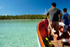 Boatmen cross the crystalline lagoon of an atoll