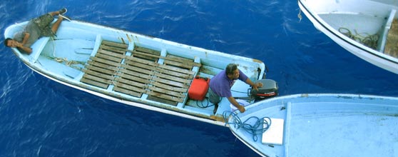 Pingelapese boatmen help to unload a visiting supply ship